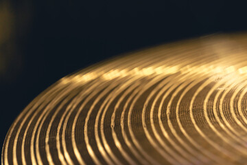 Drum cymbal close-up on a dark background.
