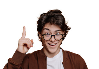 Eureka! Smart Spanish boy in white t-shirt and brown jacket pointing up by index finger at empty space on transparent background. Intelligent caucasian teenager in glasses looks at camera. Mockup.