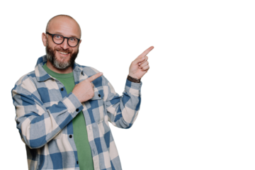 Positive Caucasian bald beardy man in plaid shirt pointing any index finger at empty space looks at camera against transparent background. Excited Italian male in glasses, teacher. Mockup, promo.