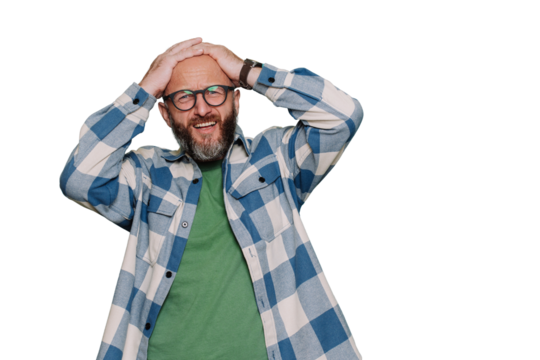 Failure! Mid adult beardy man in glasses puts hands on head in frustration in plaid shirt stands against transparent background with copy space. Unhappy caucasian man looks at camera with upset face. - Powered by Adobe