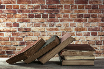 Stack of old books on a wooden table