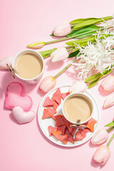 Fototapeta na wymiar Valentine's Day romantic concept. Morning coffee, a bouquet of tulips, symbolic decor