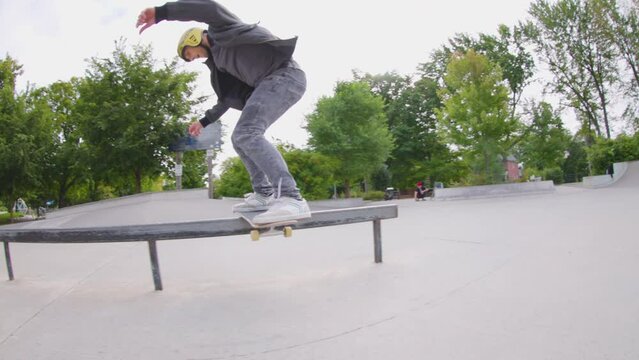 Skateboard tricks on a flat rail grind