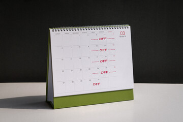 Red color words, Off Day on Fridays, Saturdays and Sundays printed on desk calendar. Four day work...