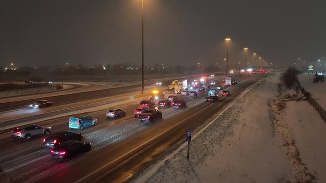 Large truck slipped on black ice, crashes into median, slows traffic snowy night