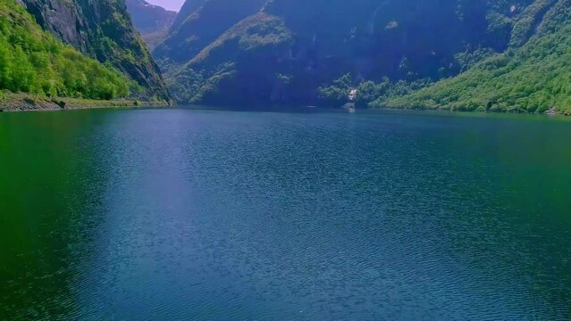 Norway Fjords with Beautiful Sun glitter is a bright, sparkling light formed when sunlight reflects from water waves. glints. vast nature and mountains of Norway