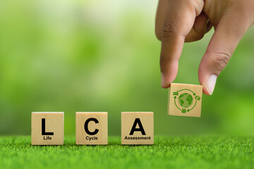 Growing sustainability. LCA-Life cycle assessment concept. hand holding wooden cube block with LCA...