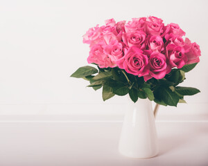 Beautiful bunch of fresh pink roses in full bloom against white background. Bouquet of flowers. Copy space for text. Valentine's day or Mother's day card.