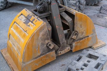 Construction site with a rusty excavator shovel