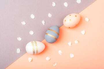 Colorful Easter eggs on pink and gray background. Top view, flat lay