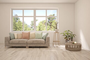Fototapeta premium White living room with sofa and summer landscape in window. Scandinavian interior design. 3D illustration