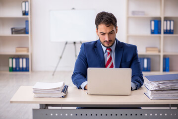 Young male employee working in the office