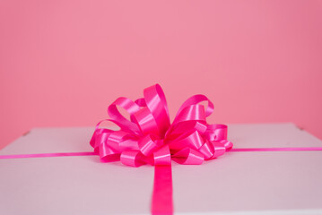 Pink bow on a gift box close-up for a birthday