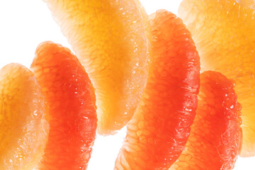 Macro portrait of grapefruit and pomelo slices without skin