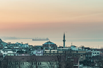Fototapeta na wymiar Fatih area of Istanbul, view from the rooftop, old houses in Fatih and Bosphorus view at sunset, Istanbul