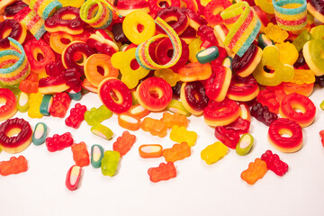 Assorted colorful gummy candies. Top view. Jelly donuts. Jelly bears. Isolated on a white background.