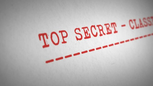 Camera tracks across the typewritten words &lsquo;Top Secret - Classified&rsquo;, underlined in red ink