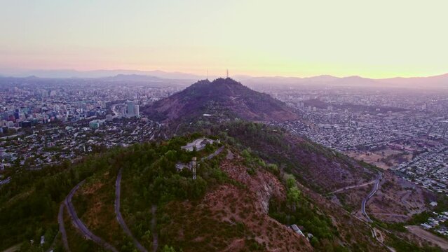 Aerial shot of the Parquemet with downtown Santiago surrounding during sunset