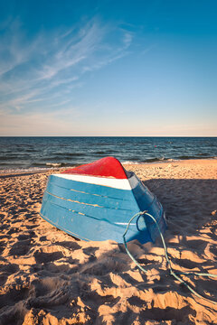 Beautiful colorful theme to welcome the holidays. Colorful boat on the beach by the blue sea. Photo taken in Jastarnia, Poland.