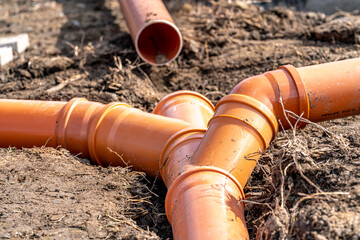 orange PVC plastic pipes on the construction site
