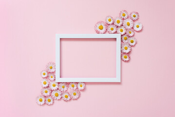 Beautiful floral arrangement. An empty text frame, daisy flowers on a pastel pink background. Valentine's Day, Easter, Birthday, Happy Women's Day, Mother's Day. Flat lay, top view, copy space