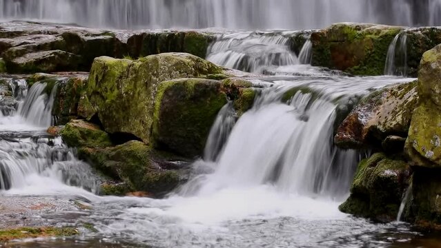 Mountain waterfalls with the rocks in the forest, panning, time lapse, close up, hd. ProRes 422 HQ.