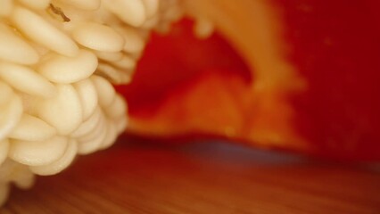 Sweet and red bell peppers, sliced with a knife on a board, sunny cloudless day. Dolly macro - Powered by Adobe