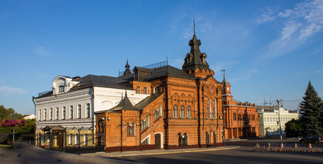Fototapeta premium VLADIMIR, RUSSIA - AUGUST, 17, 2022: the historic brick facade of the Friendship House and the City Duma building in the old town on a sunny summer day and copy space