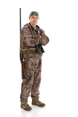 Full length portrait of duck hunter with a rifle on his shoulder and binoculars with folding arms isolated on white background. Fifty-year-old man in hunting uniform with a shotgun posing in studio
