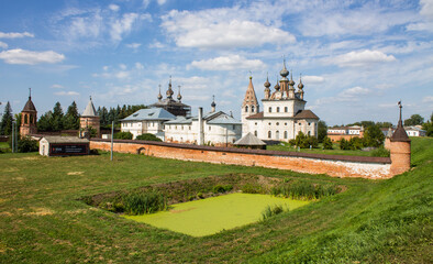 Fototapeta na wymiar Panoramic view of the old town of Yuriev-Polsky in the Vladimir region with ancient churches and houses among the green grass on a sunny summer day