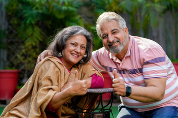 Happy senior couple showing thumps up