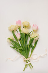 View from above tulip flowers pink and yellow color with copy space on white background for womens day, 8 March Valentines day, 14 february