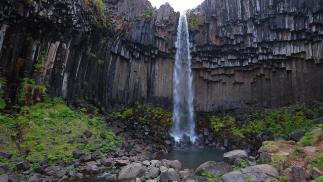 Majestic summer scene of Svartifoss (Black Fall) Waterfall. Dramatic morning view of Vatnajokull National Park, Iceland. Beauty of nature concept background.Full HD video (High Definition).