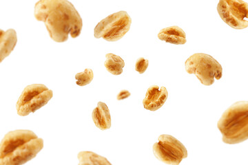 Falling puffed Wheat cereal, isolated on white background, selective focus