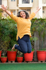 Active and happy senior woman jumping