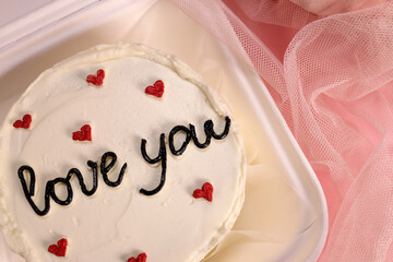 Trendy bento cake delicate biscuit with the inscription love you, a gift for mom or a loved one