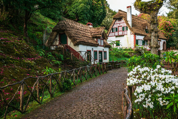 Taditional houses in Queimadas Forest Park in Santana, Madeira near Caldeirao Verde waterfall, Portugal.