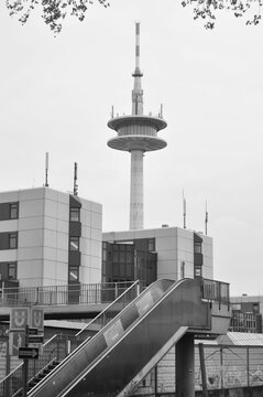 Vertical grayscale shot of a television tower and a motorway bridge on the A40 in Essen, Germany
