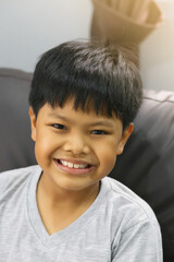 A portrait of an Asian boy smiling.  