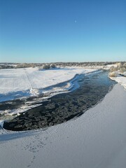 Beautiful view of a river flowing in the snow