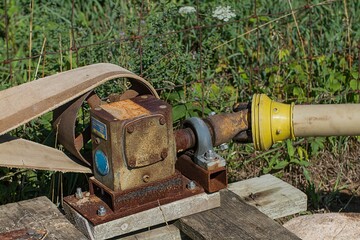 a small homemade plane on a wooden platform and a pipe attached to it