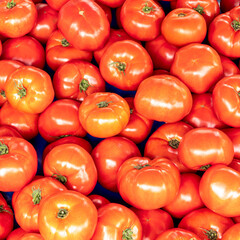 Brightly colored red, ripe tomatoes top view closeup. Seamless vegan food pattern.