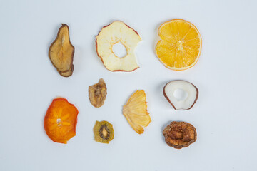 Healthy vegetarian food concept. Assortment of dried fruits, nuts and seeds on white background. Top view. Mixed nuts set closeup.