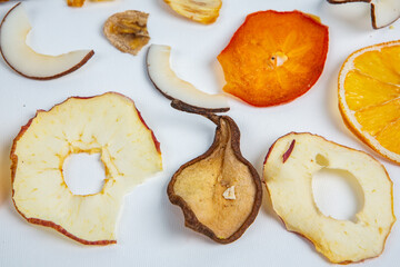 Dried fruits isolated on white background. Healthy eating concept. Top view. Healthy vegetarian food concept. Dried fruit chips.