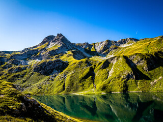 green mountain lake with blue sky and clouds © Lucasso