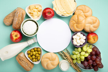 Jewish Shavuot Holiday Card. Dairy Products, Fruits, Cheese, Bread, Milk on Blue Mint Background.