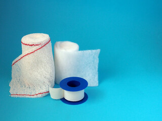 White gauze bandage roll and pad and medical tape