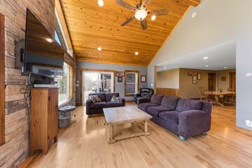Beautiful contemporary rustic cabin interior living room design with a wooden ceiling