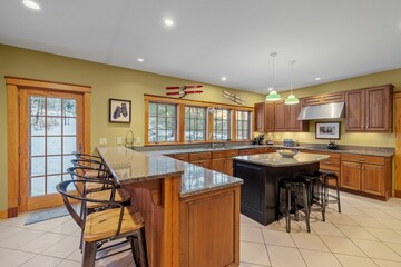 Beautiful contemporary rustic home interior kitchen design with a granite island and wooden cabinets
