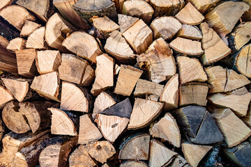 Photography on theme big wall of stacked oak tree logs in cracks